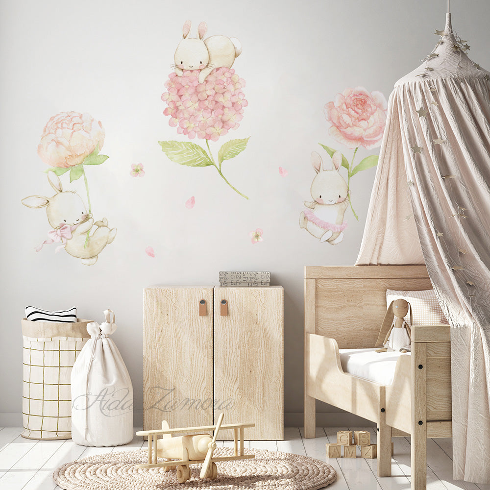 Watercolor floral bunny fabric wall decals displayed next to a beige bed canopy and wooden nursery furniture
