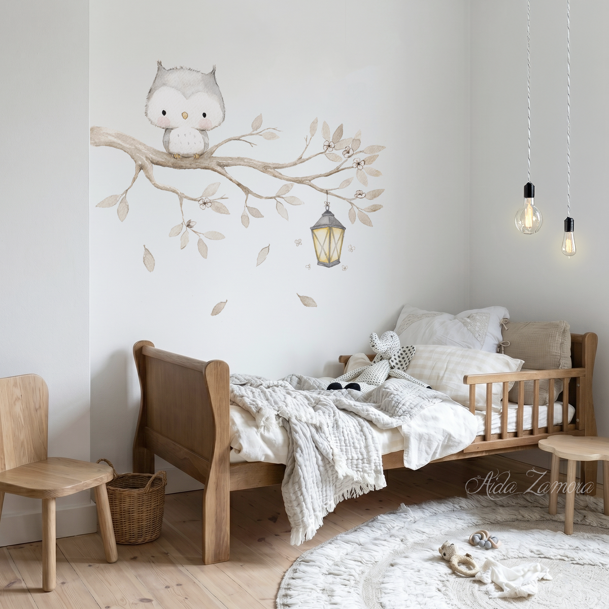 Cute watercolor owl perching on a tree branch with lantern fabric wall decal in a nursery room above a toddler bed