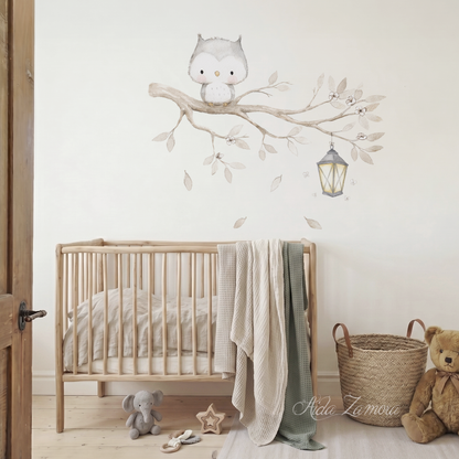 Watercolor owl on a branch fabric wall decal installed on a wall above a natural wooden baby crib