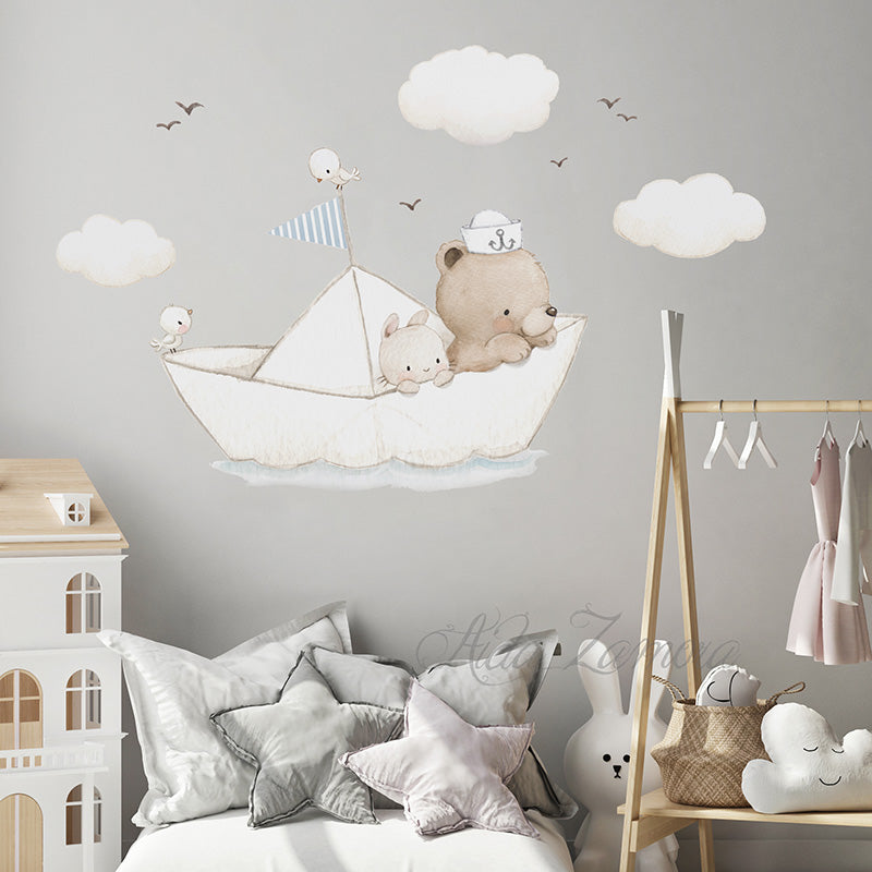 Paper Boat fabric wall decal set positioned on a grey wall above star cushions, a wooden clothes rack, and a dollhouse