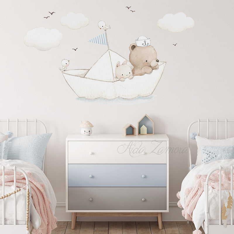 Paper Boat fabric wall decal centered above a three-drawer white and grey chest of drawers, flanked by two white metal beds with pastel bedding