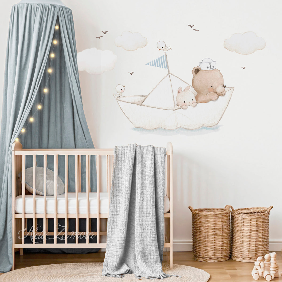 Paper boat fabric wall decal set featuring watercolor teddy bear sailor, bunny, little birds, clouds, and flying seagulls above a wooden crib