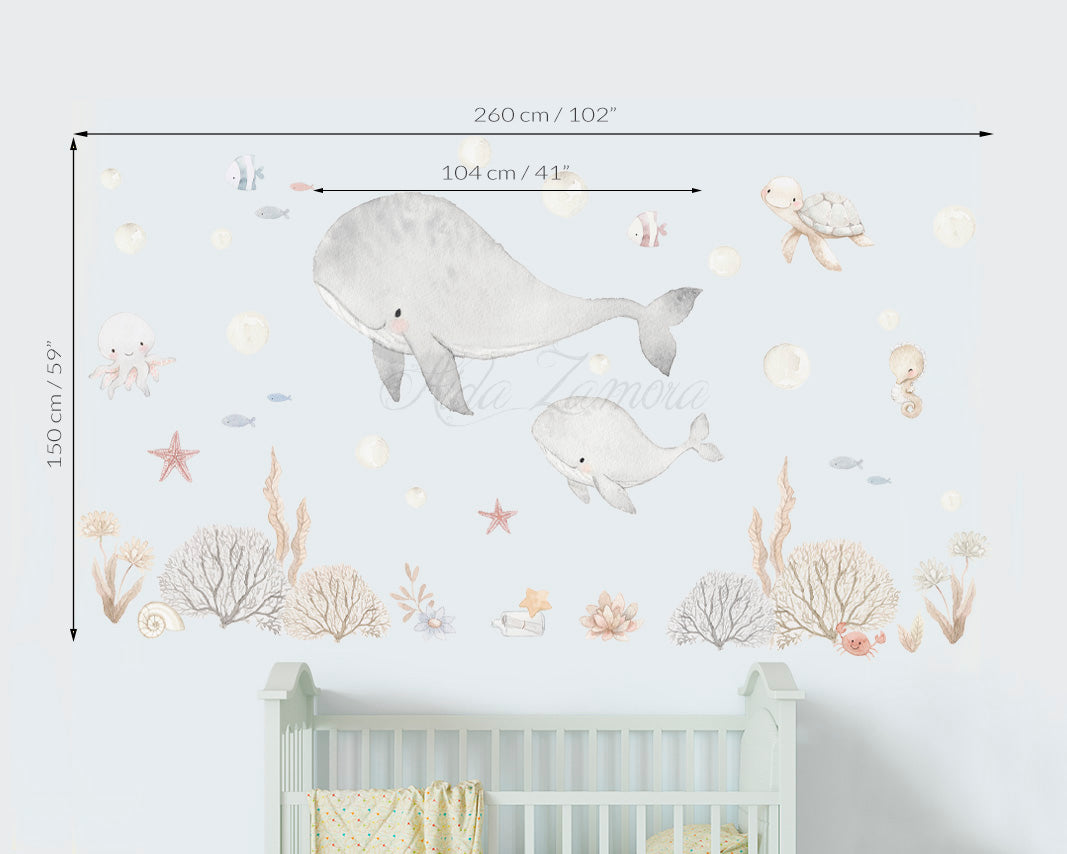 Size guide and dimensions for Sea Friends watercolor ocean nursery wall decal with whale and sea animals above a baby crib by Aida Zamora.