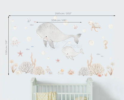 Size guide and dimensions for Sea Friends watercolor ocean nursery wall decal with whale and sea animals above a baby crib by Aida Zamora.