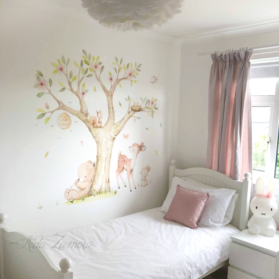 Lifestyle view of watercolor woodland forest animals fabric nursery wall decal above a crib by Aida Zamora.