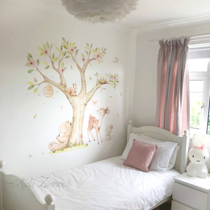 Lifestyle view of watercolor woodland forest animals fabric nursery wall decal above a crib by Aida Zamora.